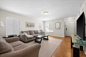 Living area with light wood finished floors and baseboards