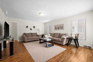 Living area with wood finished floors and baseboards
