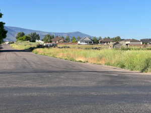View of asphalt street featuring a mountain view and a residential view