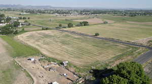 Aerial view of property and surrounding area featuring rural landscape and mountains