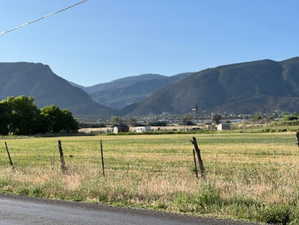 View of mountain backdrop with rural landscape