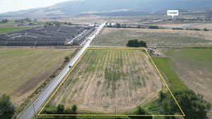 Overview of rural landscape featuring property parcel outlined and a mountain backdrop