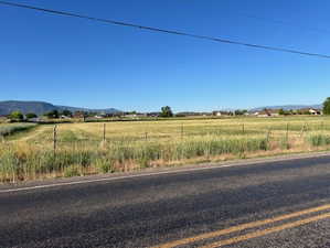 View of asphalt road with a mountain view and a view of rural / pastoral area