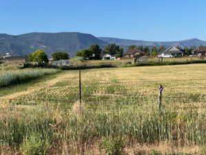 View of mountain backdrop with rural landscape