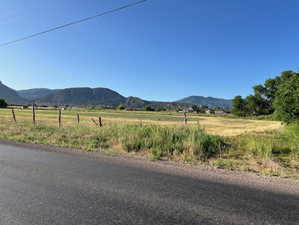 View of mountain background featuring rural landscape