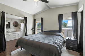 Bedroom with vaulted ceiling, crown molding, dark wood-type flooring, a ceiling fan, and ensuite bathroom