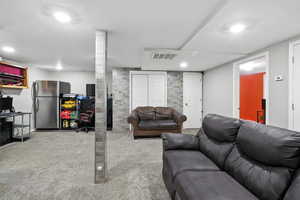 Living area with carpet and recessed lighting