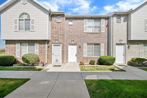 Townhome / multi-family property with brick siding