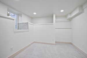 Spacious closet featuring carpet flooring