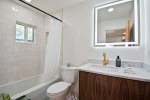 Bathroom with vanity and shower / tub combo
