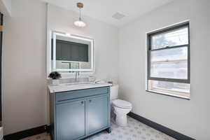 Bathroom featuring toilet and vanity