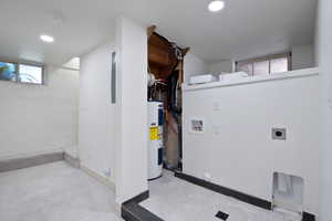 Below grade area featuring water heater, carpet, and recessed lighting