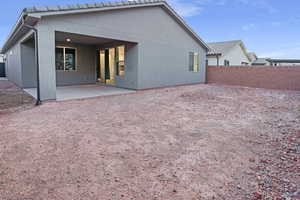 Backyard and rear view of home and patio.