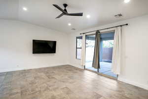 Vaulted great room with ceiling fan and 8'x8' slider door to patio.