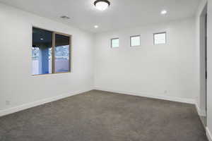 Primary bedroom with views towards the rear patio and backyard.