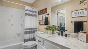 Full bath with vanity and shower / tub combo with curtain