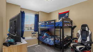 Carpeted bedroom with baseboards