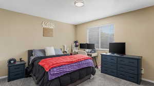 Carpeted bedroom featuring baseboards