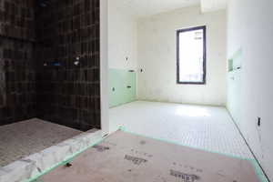 Bathroom featuring tiled shower