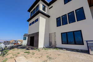 Back of property with stucco siding and a residential view