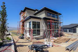 Rear view of property with stucco siding