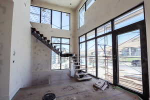 Staircase featuring a high ceiling