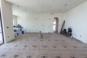 Unfurnished room featuring arched walkways