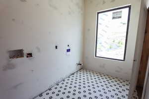 Laundry room featuring hookup for a washing machine and baseboards