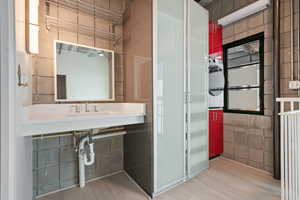 Bathroom featuring wood finished floors and ceiling fan