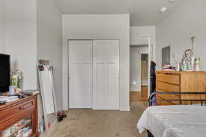 Bedroom featuring carpet floors and a closet