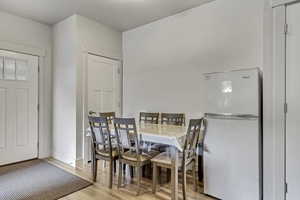Dining room with light wood finished floors and baseboards