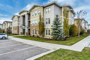 View of property featuring uncovered parking and a residential view