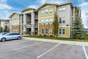 View of property featuring uncovered parking