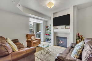 Living area with carpet and a fireplace