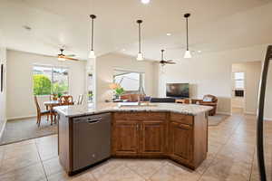 Kitchen featuring stainless steel dishwasher, a ceiling fan, open floor plan, light tile patterned floors, and recessed lighting