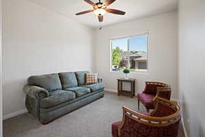 Carpeted bedroom featuring ceiling fan and baseboards