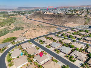 Aerial view of property's location with a mountain backdrop and nearby suburban area