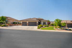 Mediterranean / spanish-style home with stone siding, a garage, concrete driveway, stucco siding, and a tiled roof
