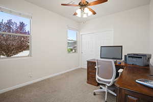 Bedroom with a ceiling fan and light colored carpet