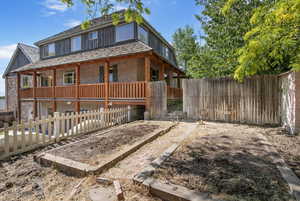 View of vegetable garden, and a fenced backyard