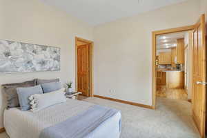 Bedroom featuring baseboards and light carpet