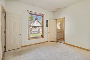 Carpeted bedroom with baseboards