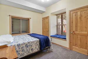 Carpeted bedroom featuring baseboards