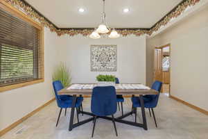 Dining area with a chandelier and recessed lighting