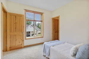 Bedroom with carpet floors and baseboards