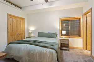 Bedroom with carpet floors, ceiling fan, and a closet