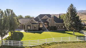 View of front facade with a chimney and stone siding