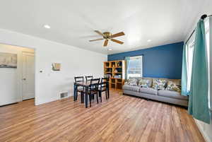 Living room featuring a ceiling fan, light wood-style floors, and recessed lighting