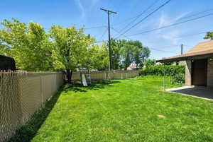 Fenced backyard featuring a patio