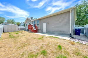 Back of house featuring a fenced backyard and a storage shed